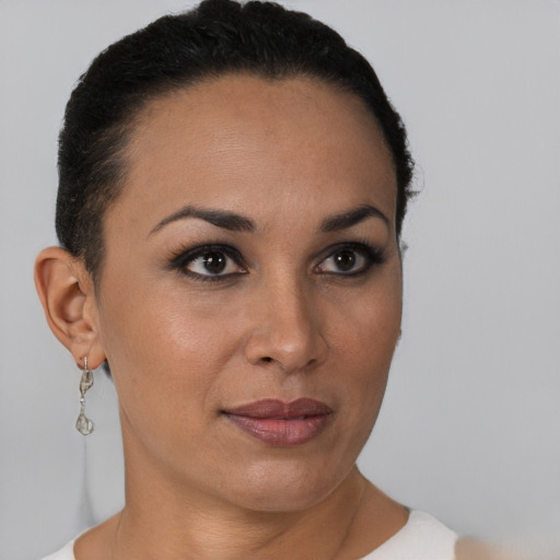 Joyful latino young-adult female with short  brown hair and brown eyes