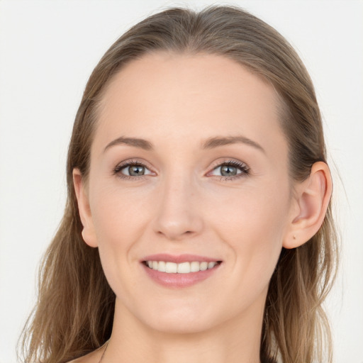 Joyful white young-adult female with long  brown hair and blue eyes