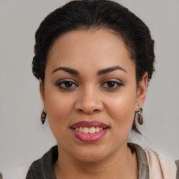 Joyful latino young-adult female with long  brown hair and brown eyes