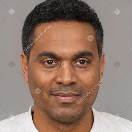 Joyful black adult male with short  black hair and brown eyes