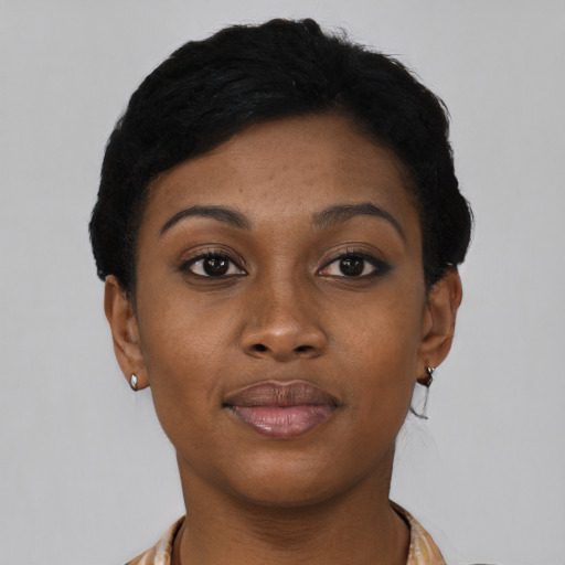 Joyful black young-adult female with short  black hair and brown eyes