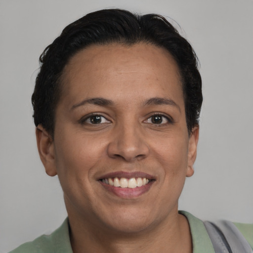 Joyful latino adult female with short  brown hair and brown eyes