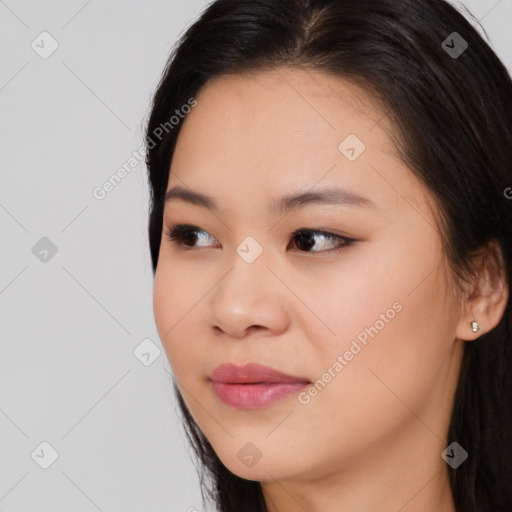 Joyful asian young-adult female with long  brown hair and brown eyes