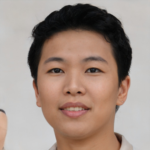 Joyful asian young-adult female with short  black hair and brown eyes