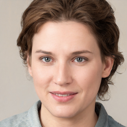 Joyful white young-adult female with medium  brown hair and blue eyes