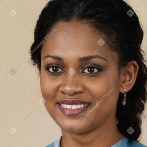 Joyful black young-adult female with long  brown hair and brown eyes
