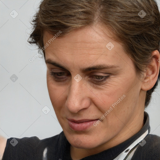 Joyful white adult female with medium  brown hair and brown eyes