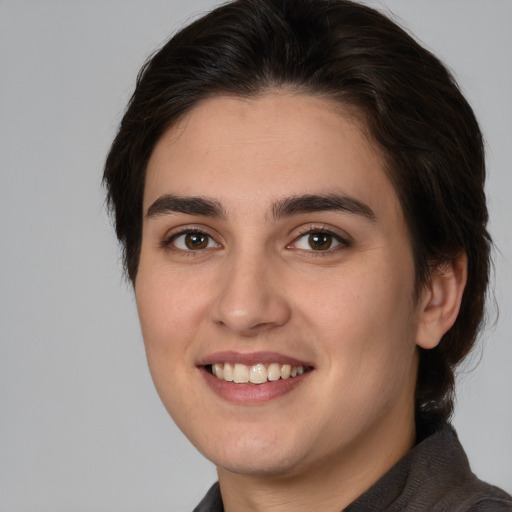 Joyful white young-adult female with medium  brown hair and brown eyes