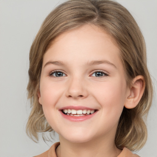 Joyful white child female with medium  brown hair and grey eyes