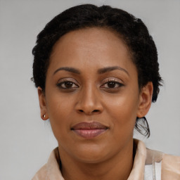 Joyful black young-adult female with short  brown hair and brown eyes