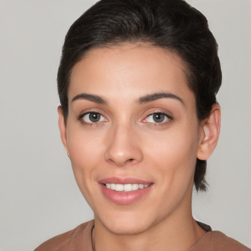 Joyful white young-adult female with short  brown hair and brown eyes