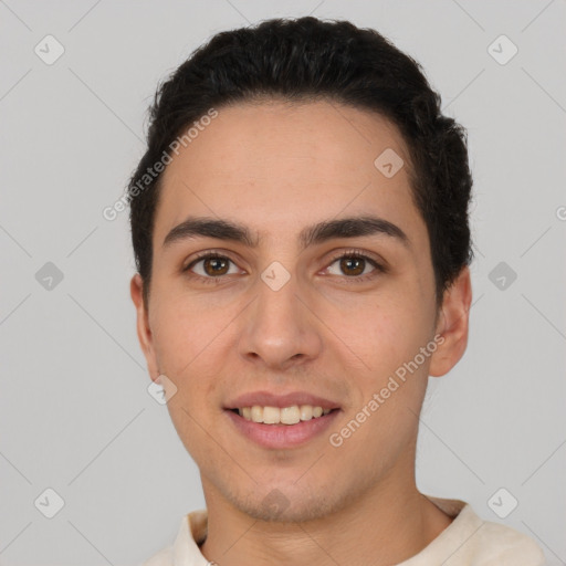 Joyful white young-adult male with short  black hair and brown eyes