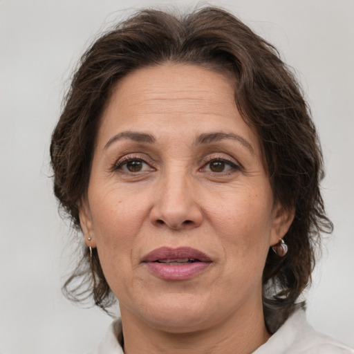 Joyful white adult female with medium  brown hair and brown eyes