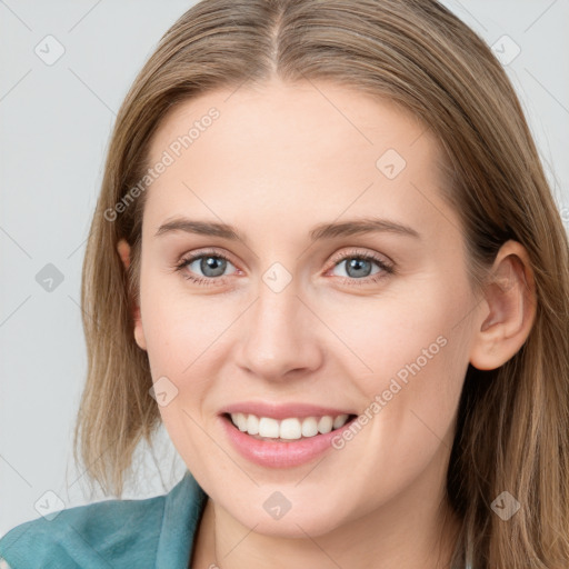 Joyful white young-adult female with long  brown hair and blue eyes