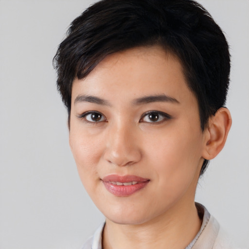 Joyful asian young-adult female with short  black hair and brown eyes