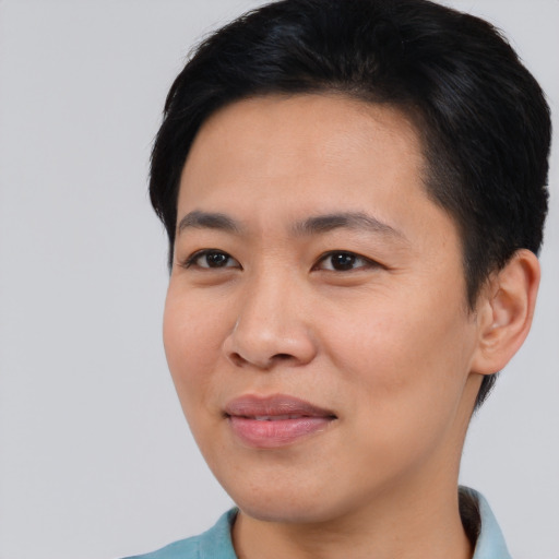 Joyful asian young-adult female with short  black hair and brown eyes