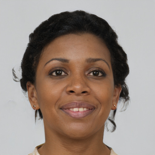 Joyful black young-adult female with short  brown hair and brown eyes