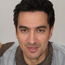 Joyful white adult male with short  black hair and brown eyes