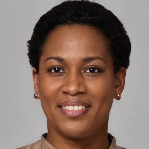 Joyful black young-adult female with short  black hair and brown eyes