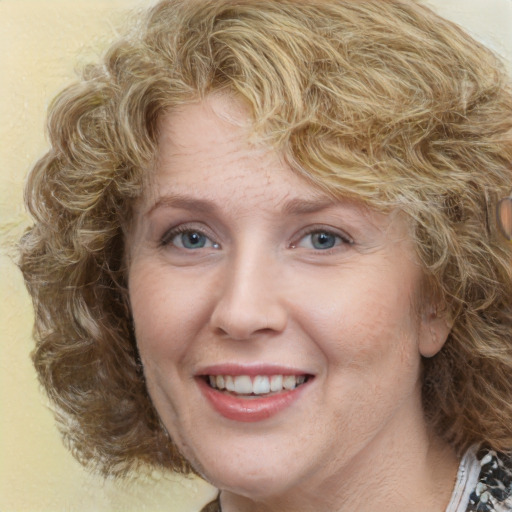 Joyful white adult female with medium  brown hair and green eyes