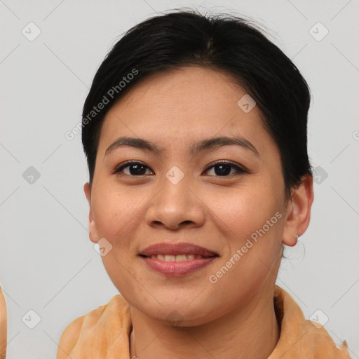 Joyful asian young-adult female with short  brown hair and brown eyes