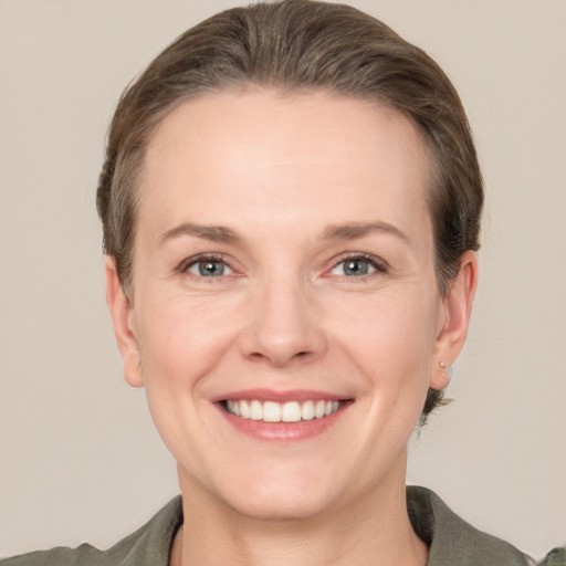 Joyful white adult female with short  brown hair and grey eyes