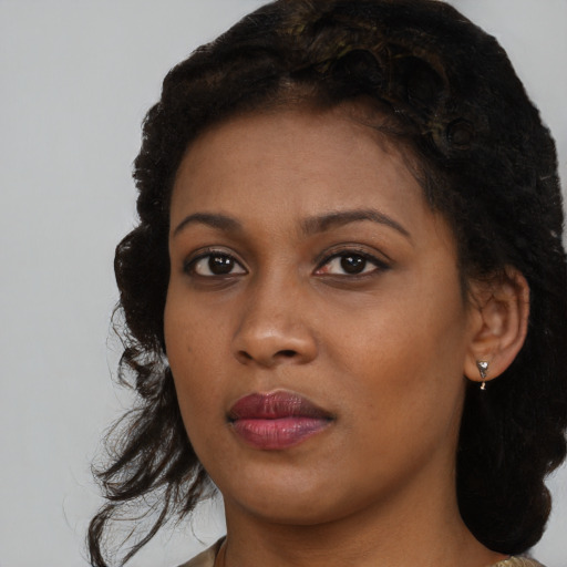 Neutral black young-adult female with medium  brown hair and brown eyes