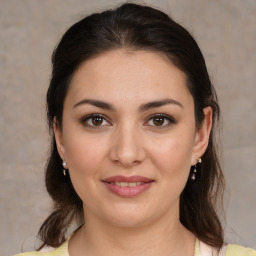 Joyful white young-adult female with medium  brown hair and brown eyes