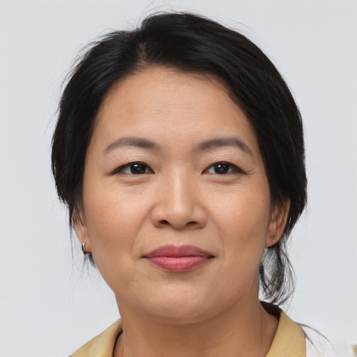 Joyful asian adult female with medium  brown hair and brown eyes