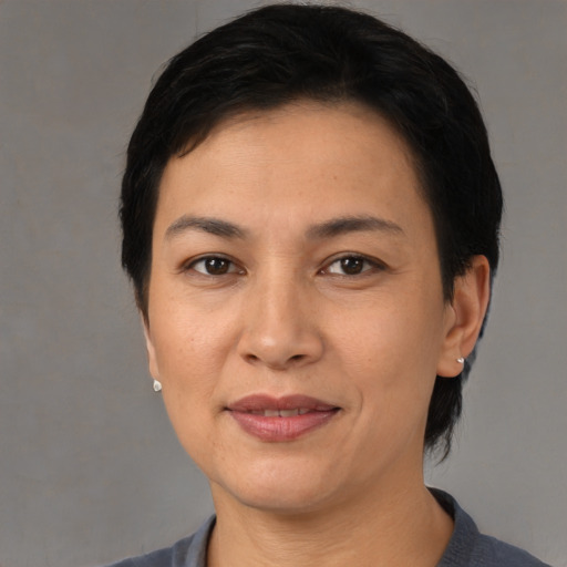 Joyful asian adult female with short  black hair and brown eyes