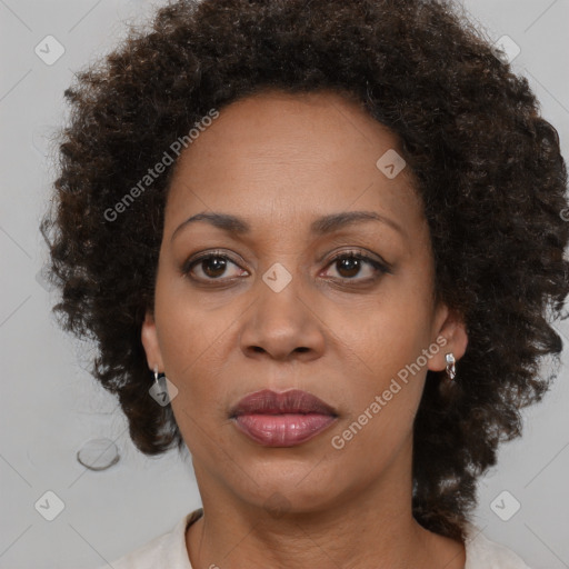 Joyful black adult female with medium  brown hair and brown eyes