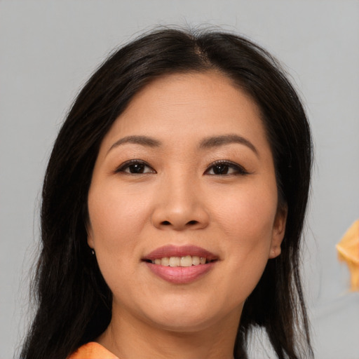 Joyful asian young-adult female with long  brown hair and brown eyes