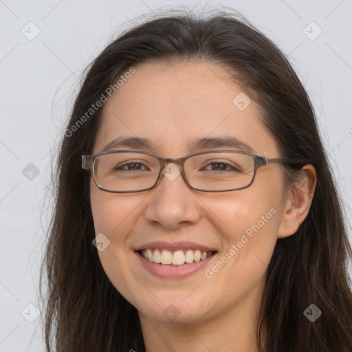 Joyful white adult female with long  brown hair and brown eyes