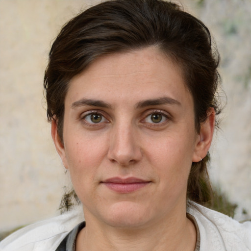 Joyful white young-adult female with medium  brown hair and green eyes