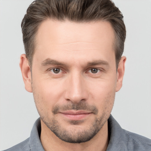 Joyful white adult male with short  brown hair and brown eyes