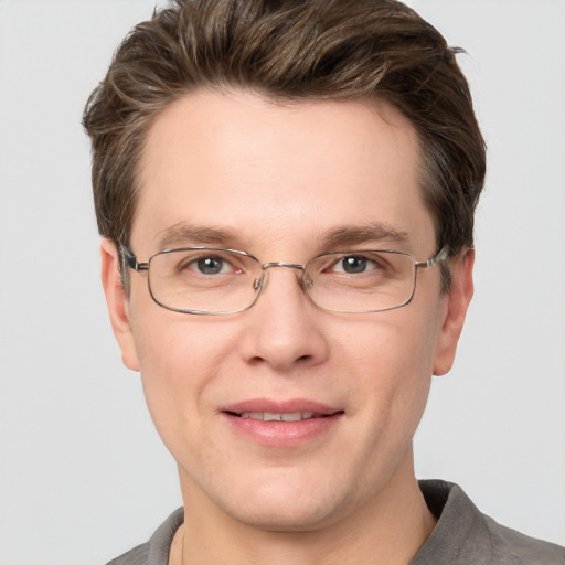 Joyful white adult male with short  brown hair and grey eyes