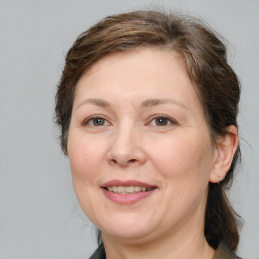 Joyful white adult female with medium  brown hair and brown eyes