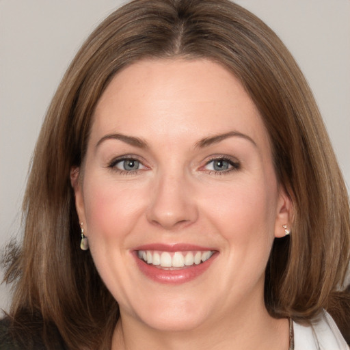 Joyful white adult female with medium  brown hair and brown eyes