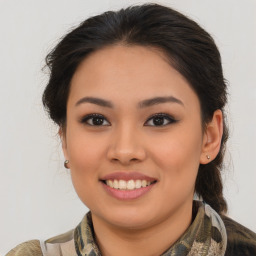 Joyful latino young-adult female with medium  brown hair and brown eyes