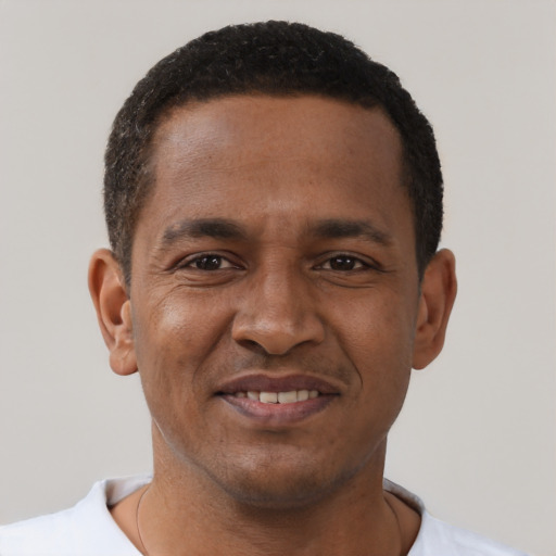 Joyful black young-adult male with short  black hair and brown eyes