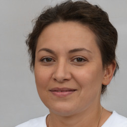 Joyful white adult female with short  brown hair and brown eyes