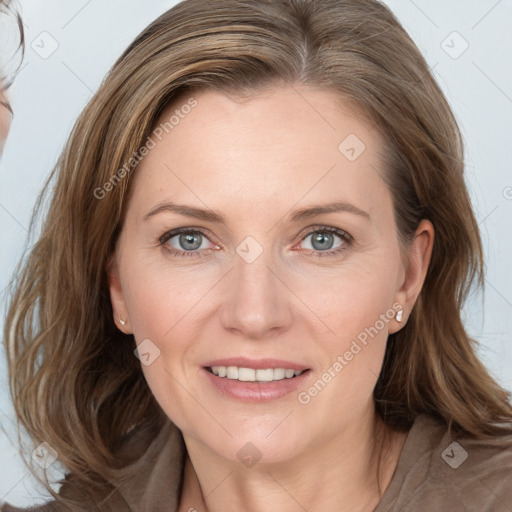 Joyful white adult female with medium  brown hair and blue eyes