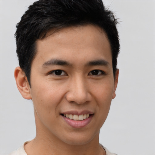 Joyful asian young-adult male with short  brown hair and brown eyes