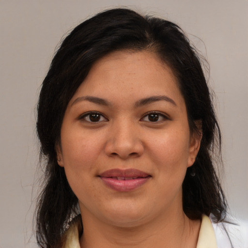 Joyful latino young-adult female with medium  brown hair and brown eyes