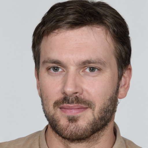 Joyful white adult male with short  brown hair and brown eyes