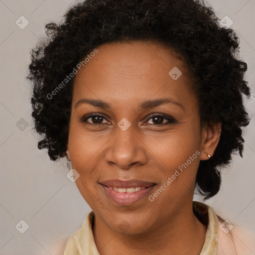 Joyful black adult female with medium  brown hair and brown eyes