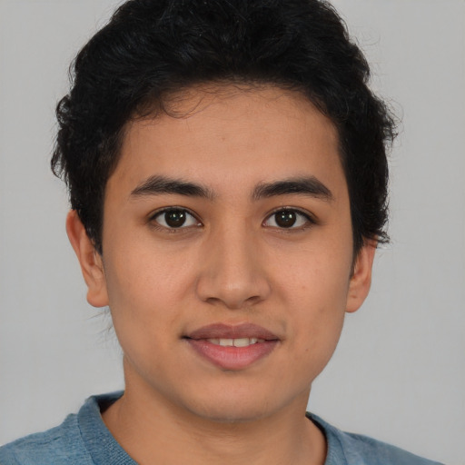 Joyful latino young-adult male with short  brown hair and brown eyes