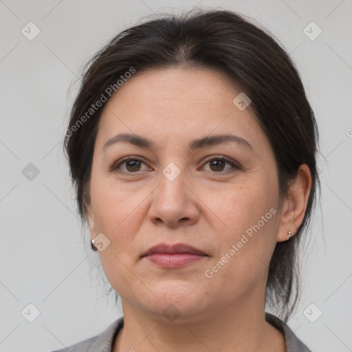 Joyful white adult female with medium  brown hair and brown eyes