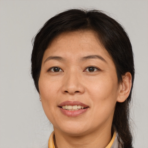 Joyful asian adult female with medium  brown hair and brown eyes