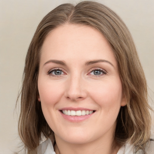 Joyful white young-adult female with medium  brown hair and green eyes